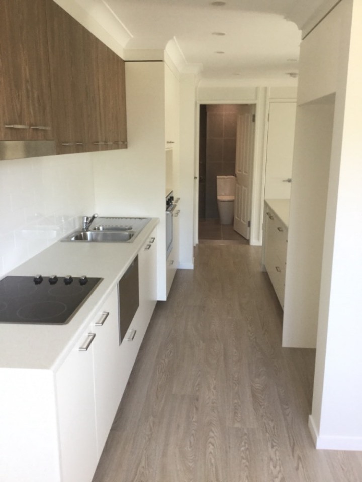 Custom kitchen with soft close drawers, waterfall stone benchtops and new appliances