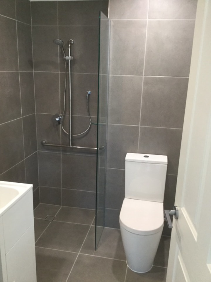 Sparkling new bathroom includes zero transition flooring, anti-slip tiles and built-in grab rail